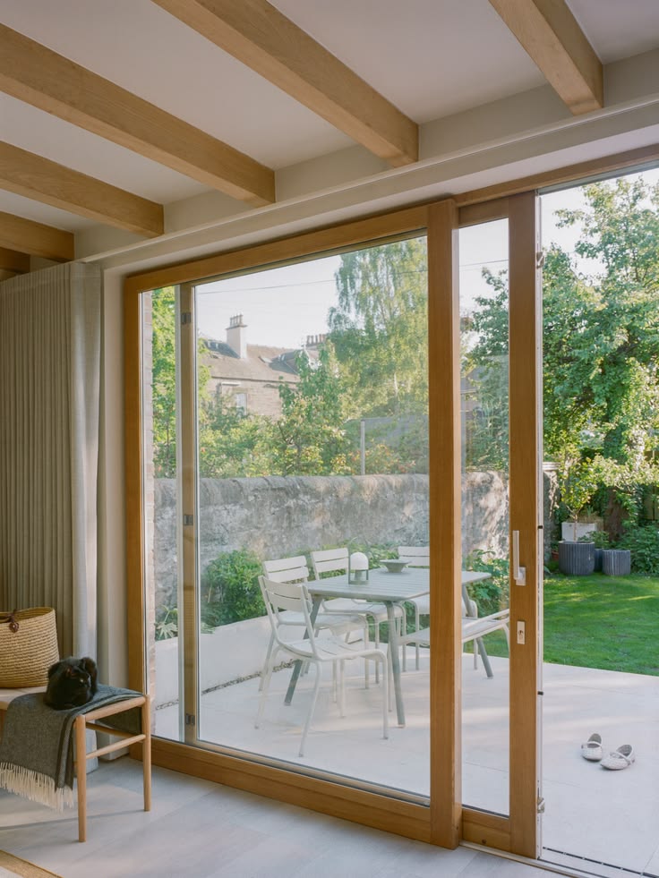 Grande baie coulissante en bois avec vue sur le jardin